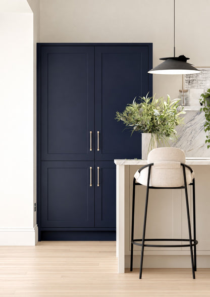 Indigo blue Shaker Door larder cabinets beside an ivory island