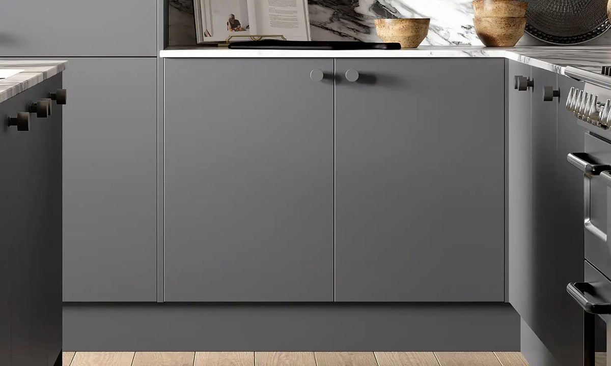Anthracite grey Slab Door base cabinets with round handles and marble splashback